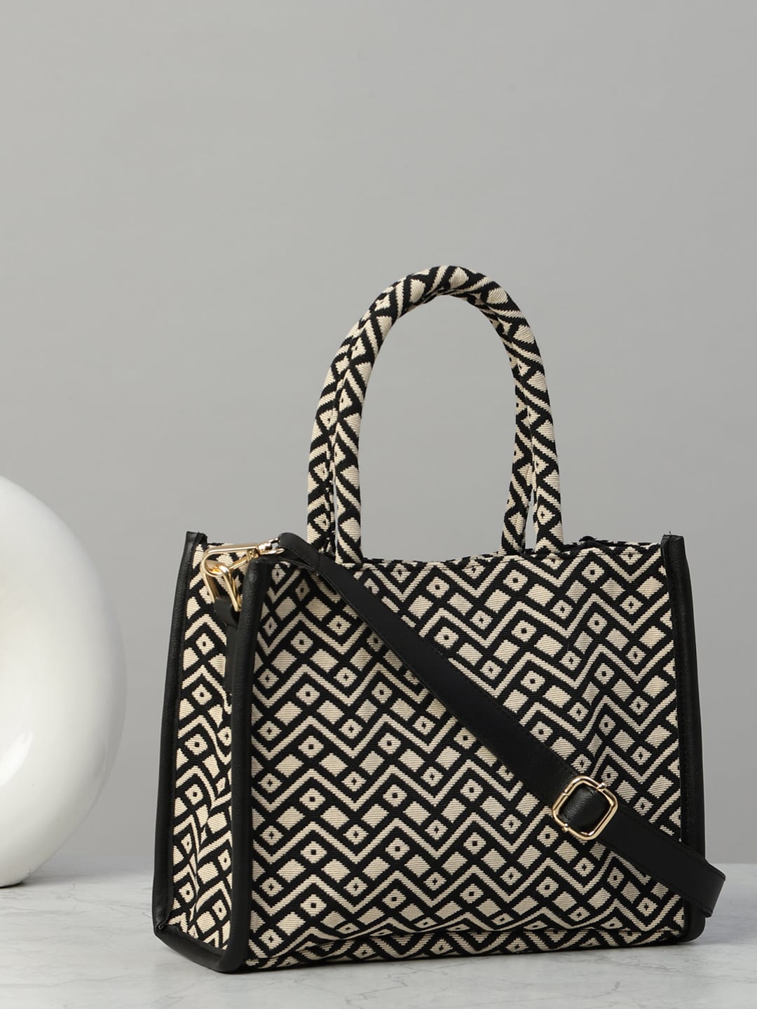 

DEEBACO Geometric Self Design Structured Handheld Bag, Black