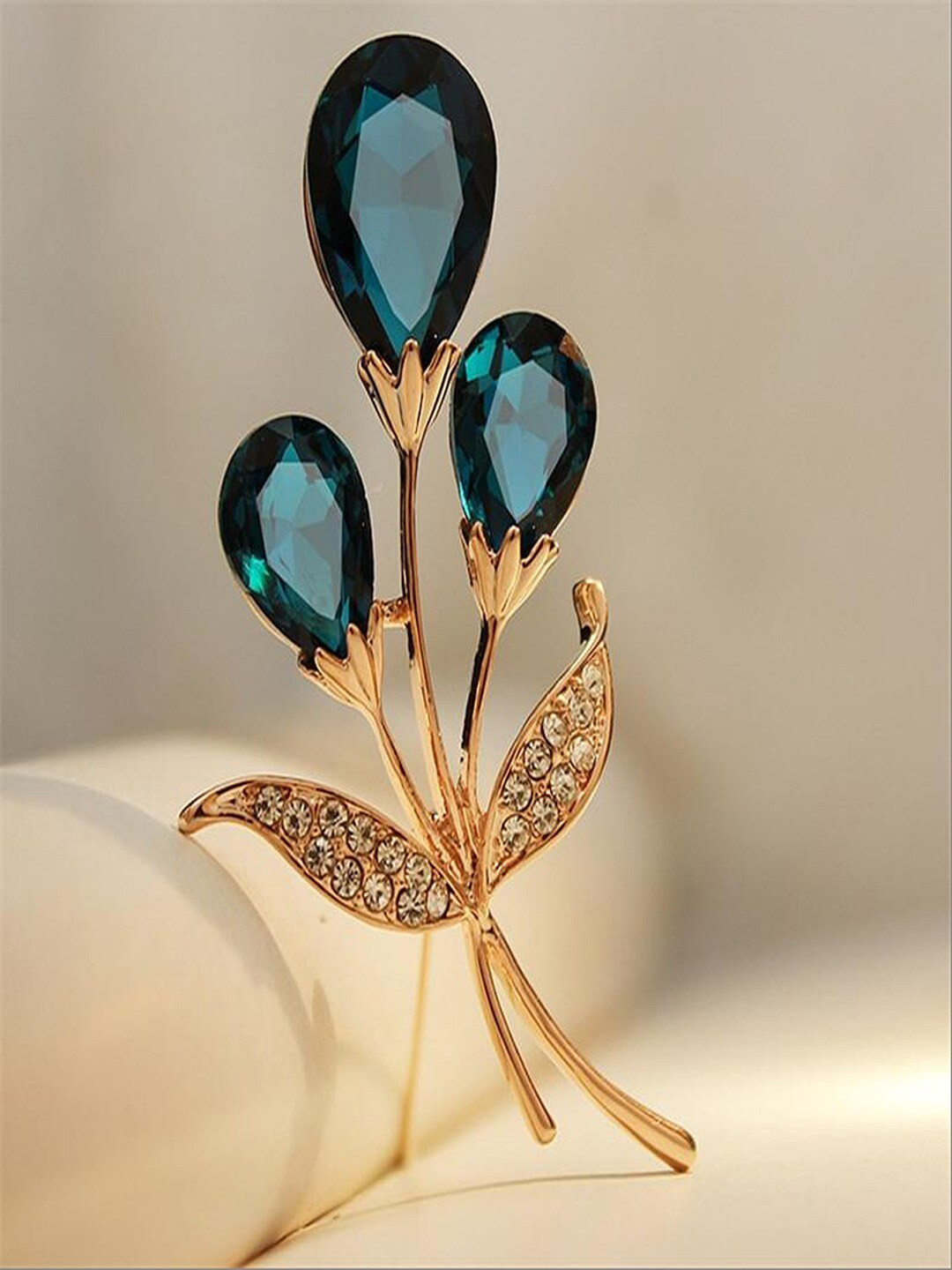 

UNIVERSITY TRENDZ Women Gold-Plated Crystal Studded Floral-Shaped Brooch, Blue