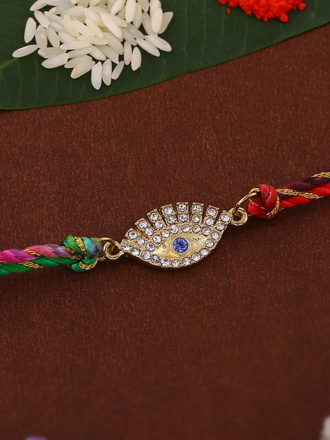 

Estele Gold-Plated Artificial Crystal-Studded Evil Eye Charm Thread Rakhi