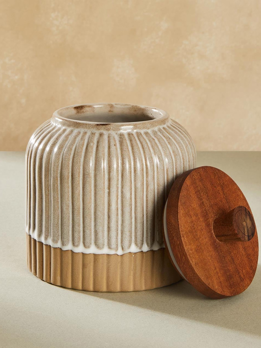 

Fabindia White & Beige Textured Ceramic Small Jar