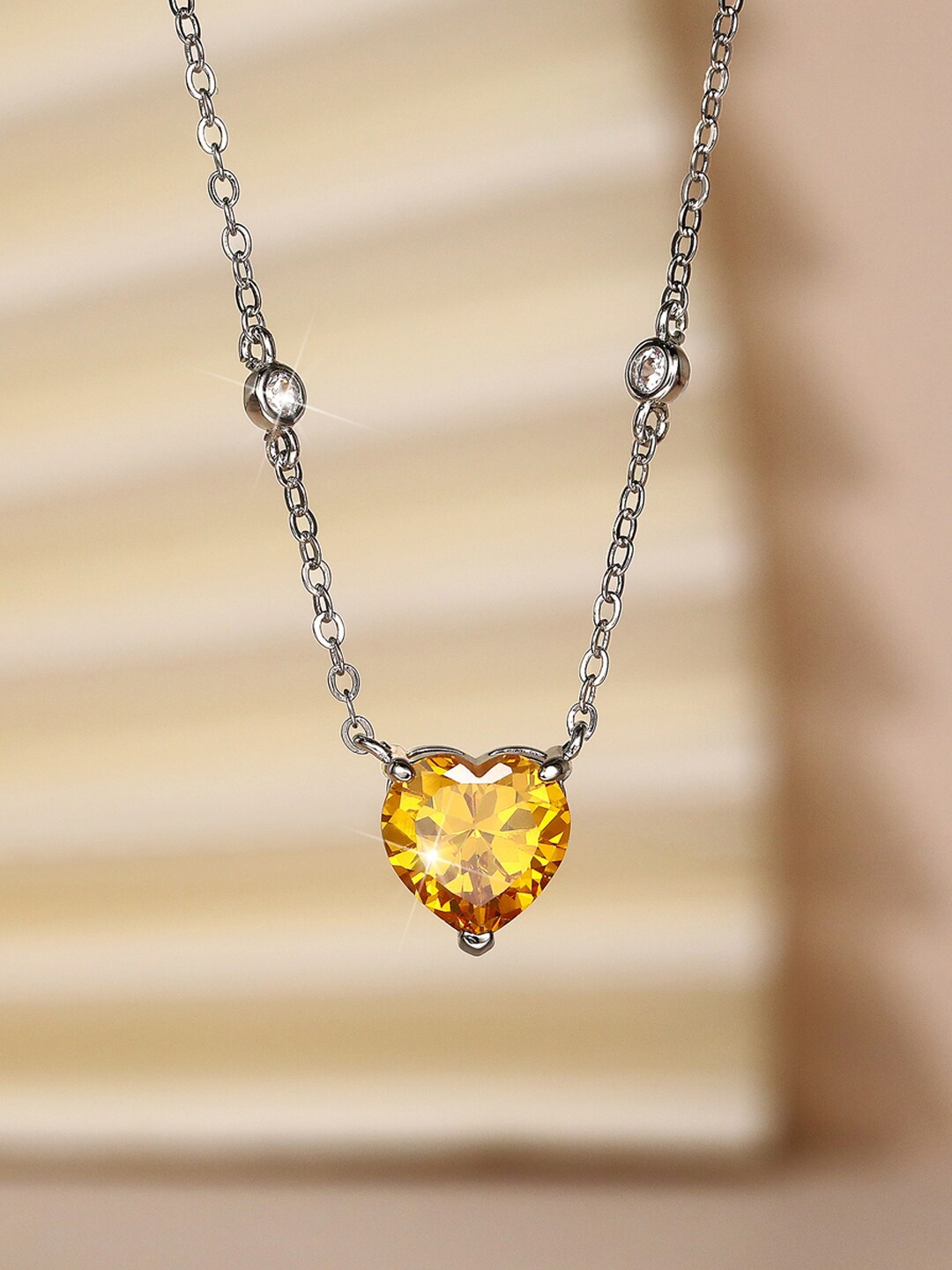 

Designs & You Silver Plated American Diamond Studded Heart Shaped Pendant With Chain, Yellow
