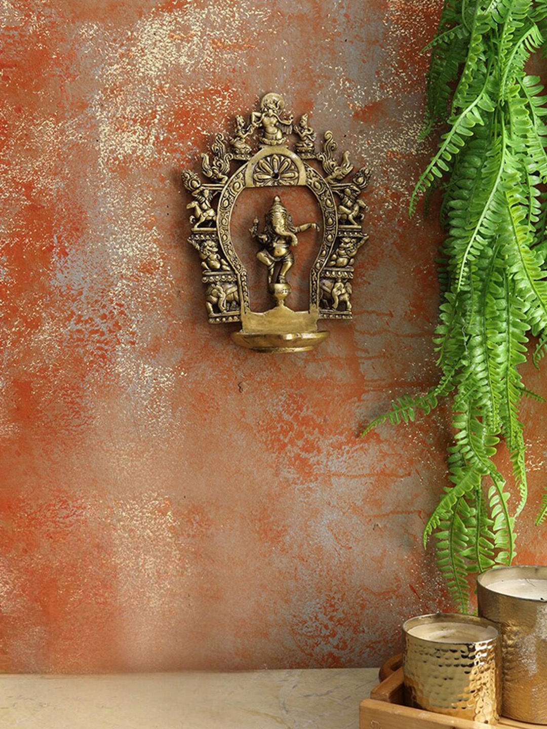 

Two Moustaches Beige Brass Carving Dancing Ganesha Design Diya & Prabhavali Frame