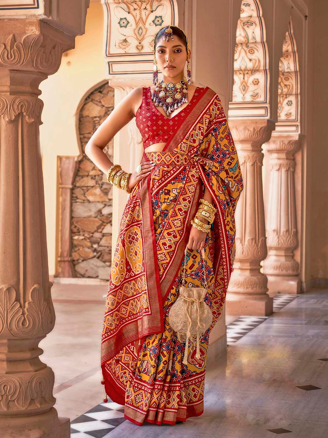 

Mitera Yellow & Red Ethnic Motifs Printed Zari Patola Saree