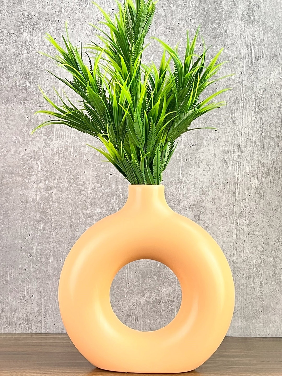 

Akaar Green Artificial Fern Plant with Orange Donut Pot