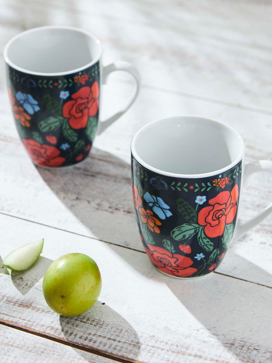 

Chumbak Green & Red 2 Pieces Floral Printed Ceramic Glossy Mugs 1.44L each