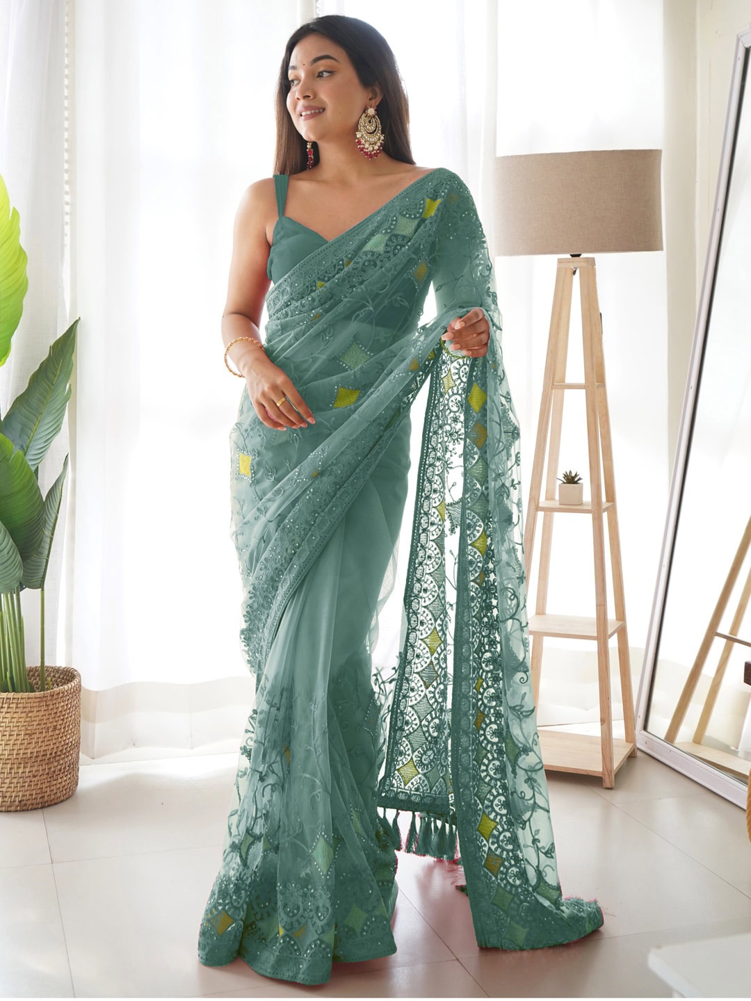 

Saree mall Teal & Yellow Embellished Embroidered Net Sarees