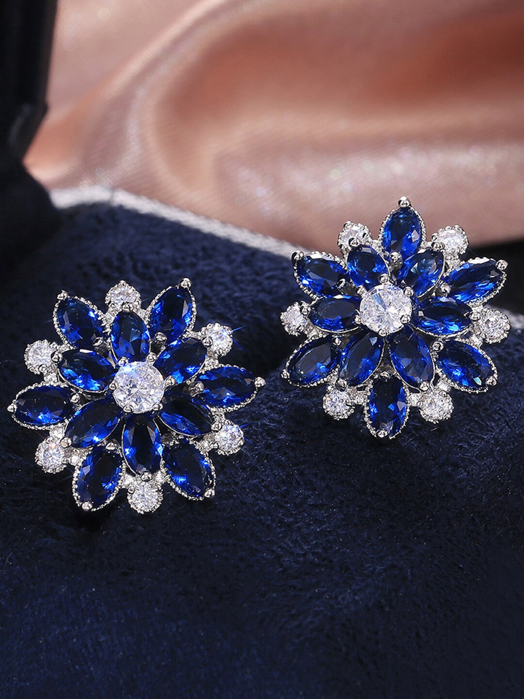 

Designs & You Silver Plated American Diamond Studded Floral Studs Earrings