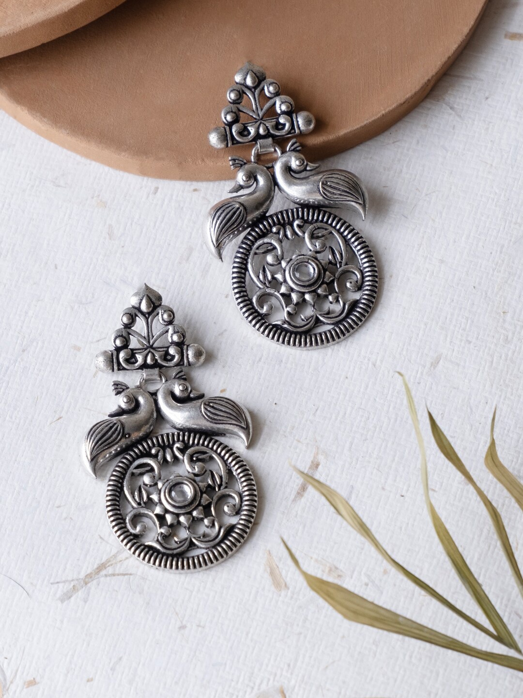 

Infuzze Silver-Plated Peacock Shaped Oxidised Drop Earrings