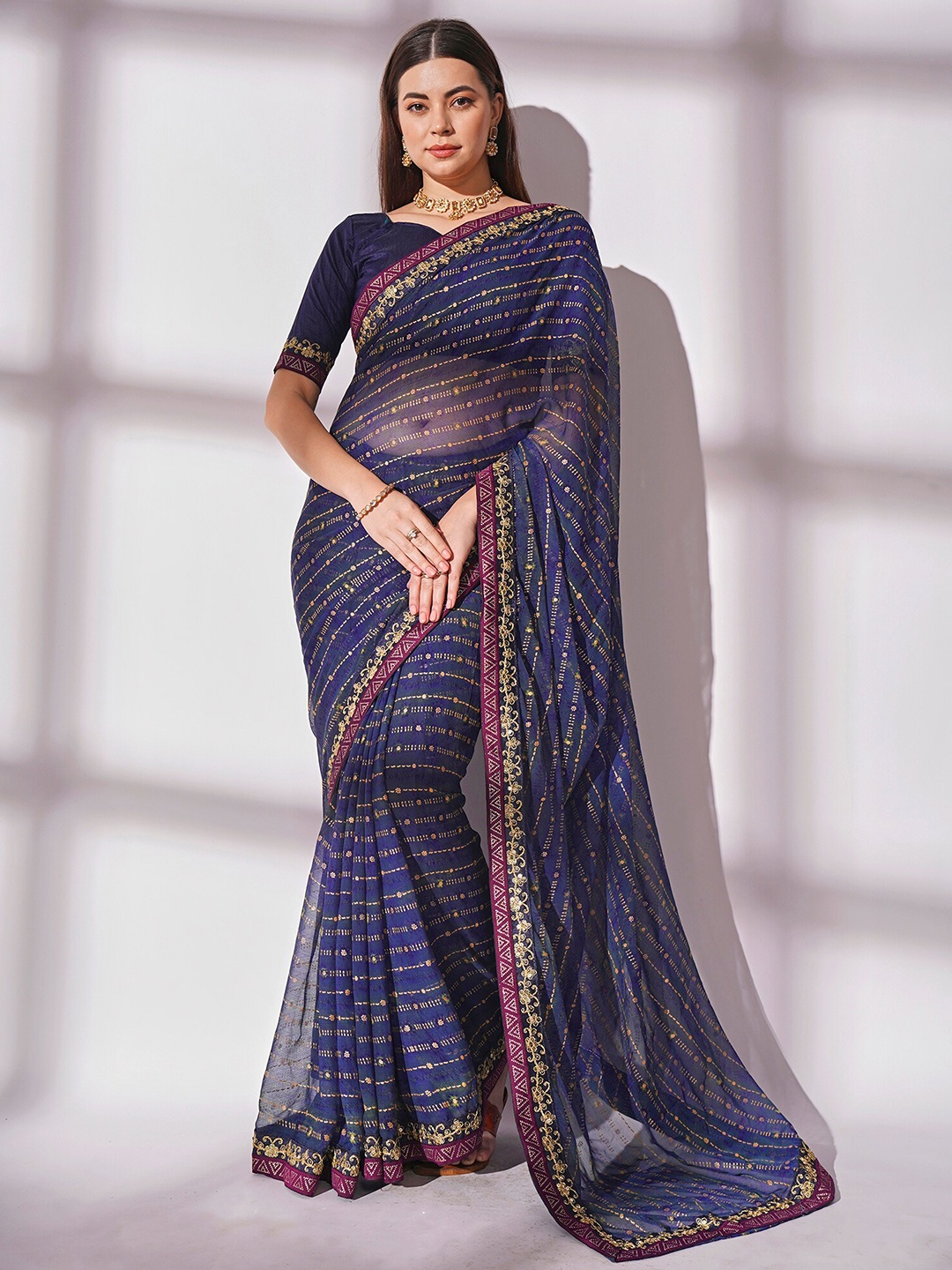 

Mitera Blue Ethnic Motifs Sequinned Pure Georgette Saree
