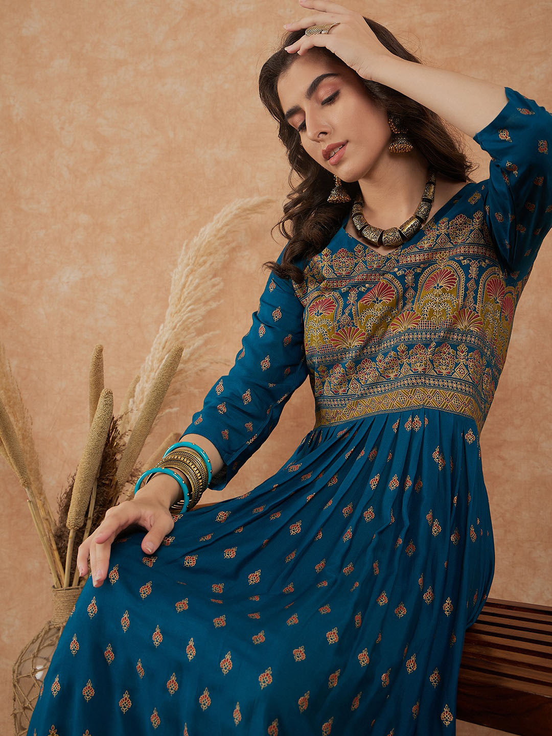 

Sangria Teal & Gold Toned Ethnic Motifs Printed V Neck Gathered Maxi Ethnic Dress