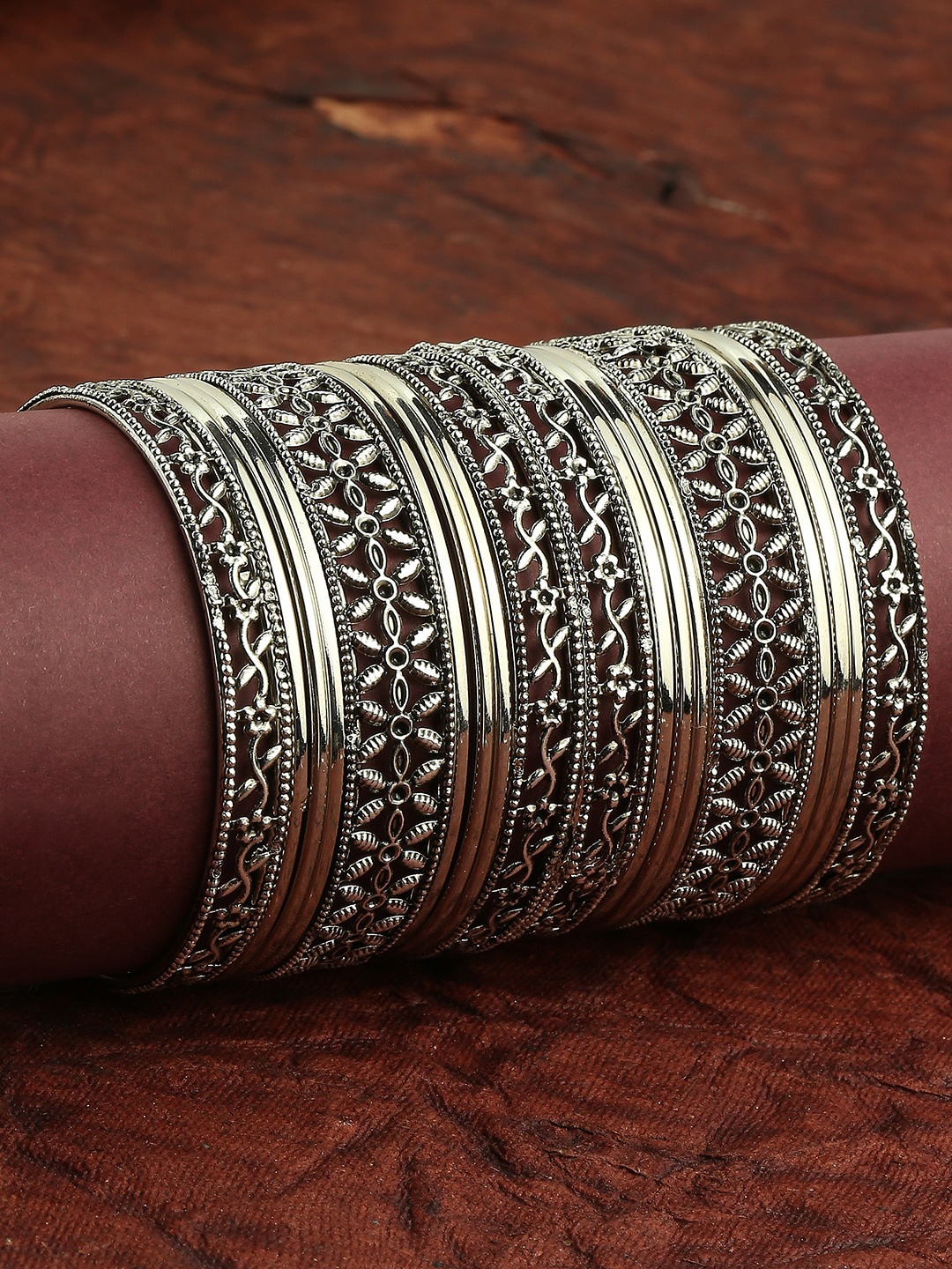 

OOMPH Set Of 18 Silver Plated Oxidised Floral Design Bangles