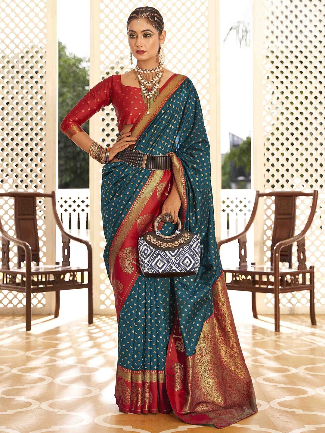 

Mitera Teal & Red Ethnic Motifs Woven Design Zari Banarasi Saree