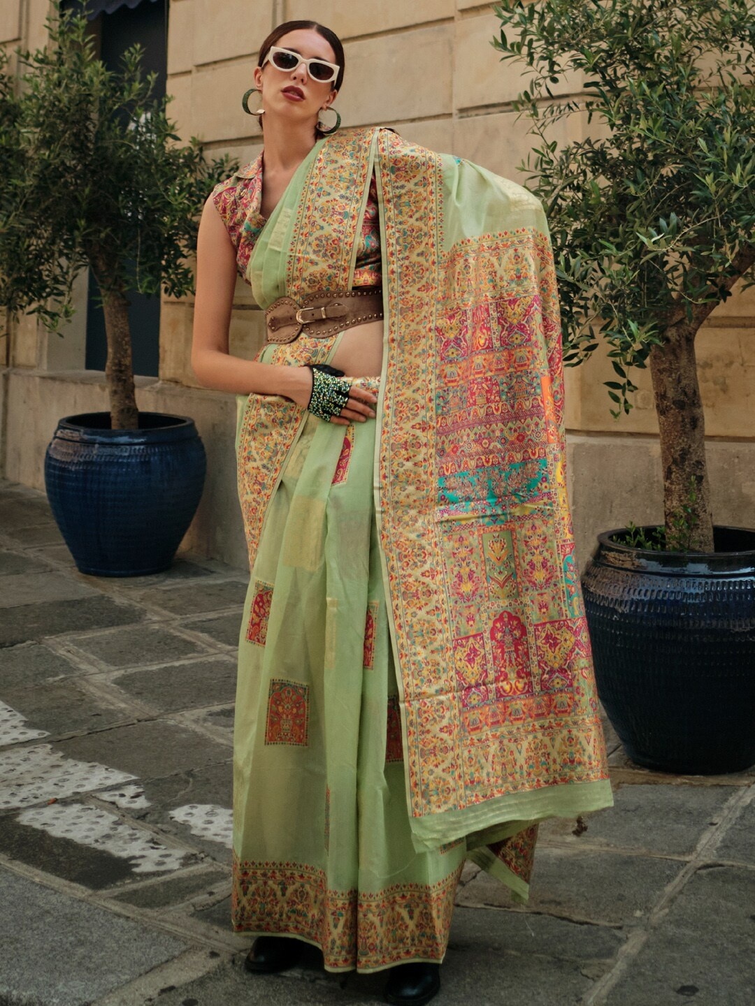 

Mitera Green & Orange Ethnic Motifs Woven Design Zari Banarasi Saree