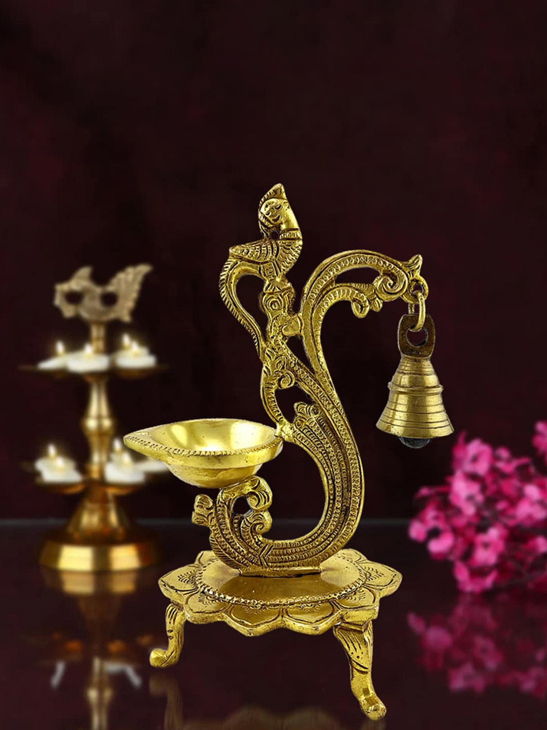 

Two Moustaches Gold-Toned Ethnic Carved Peacock Design Brass Diya with Bell