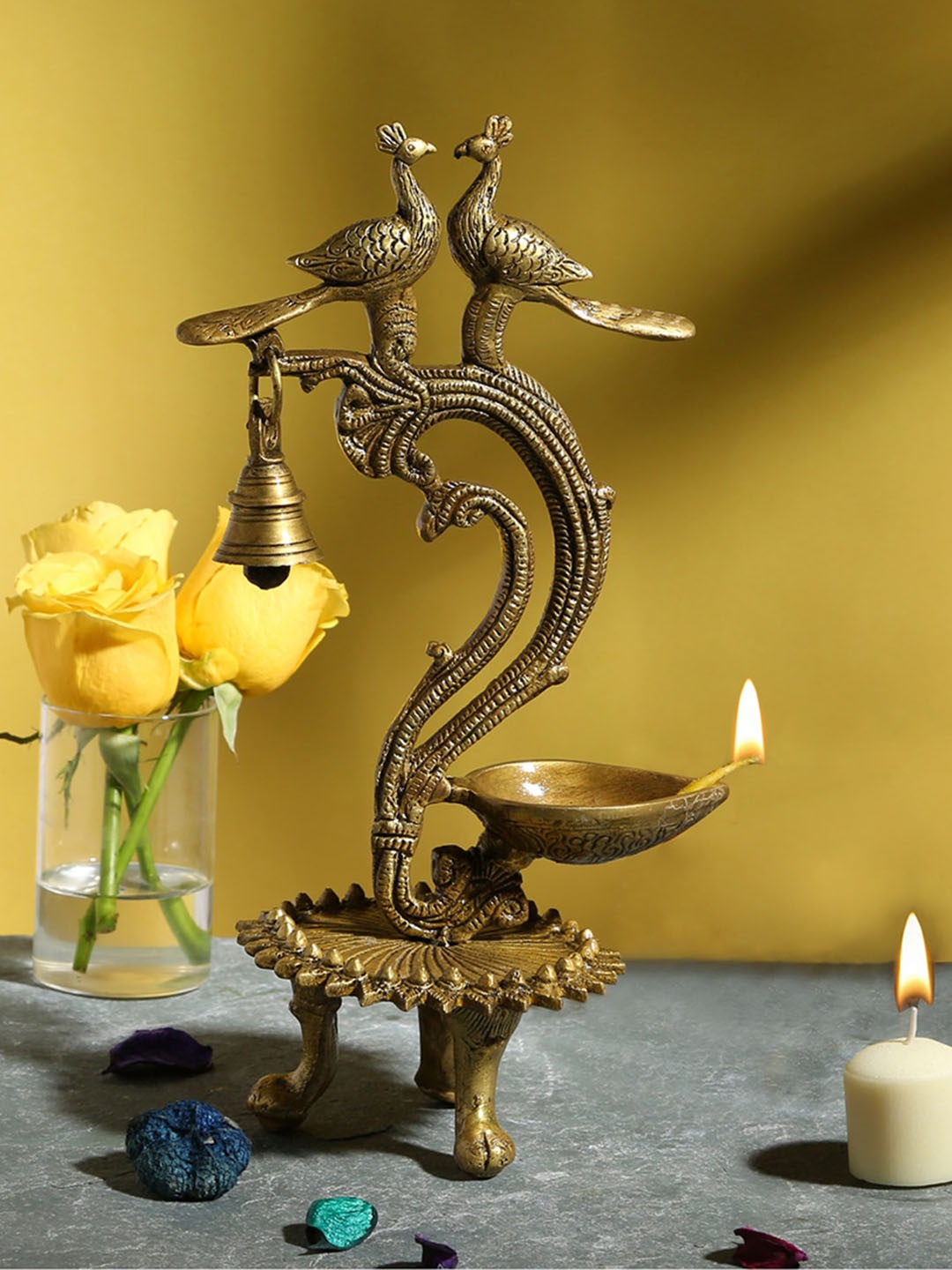 

Two Moustaches Beige Brass Ethnic Carved Twin Peacock Design Over Diya