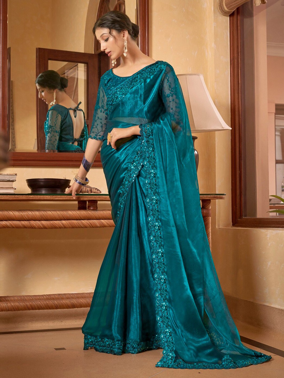 

Mitera Teal Embroidered Pure Chiffon Saree