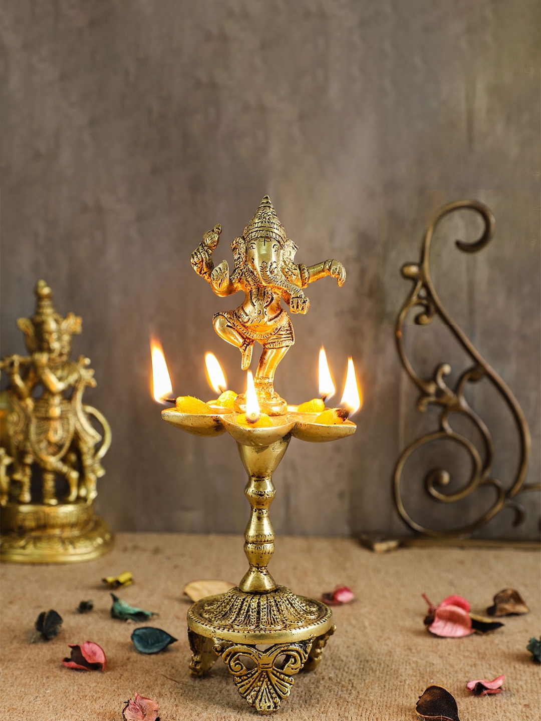 

Two Moustaches Gold Toned Dancing Lord Ganesha Over Ethnic Legs Five Oil Wick Brass Diya, Copper