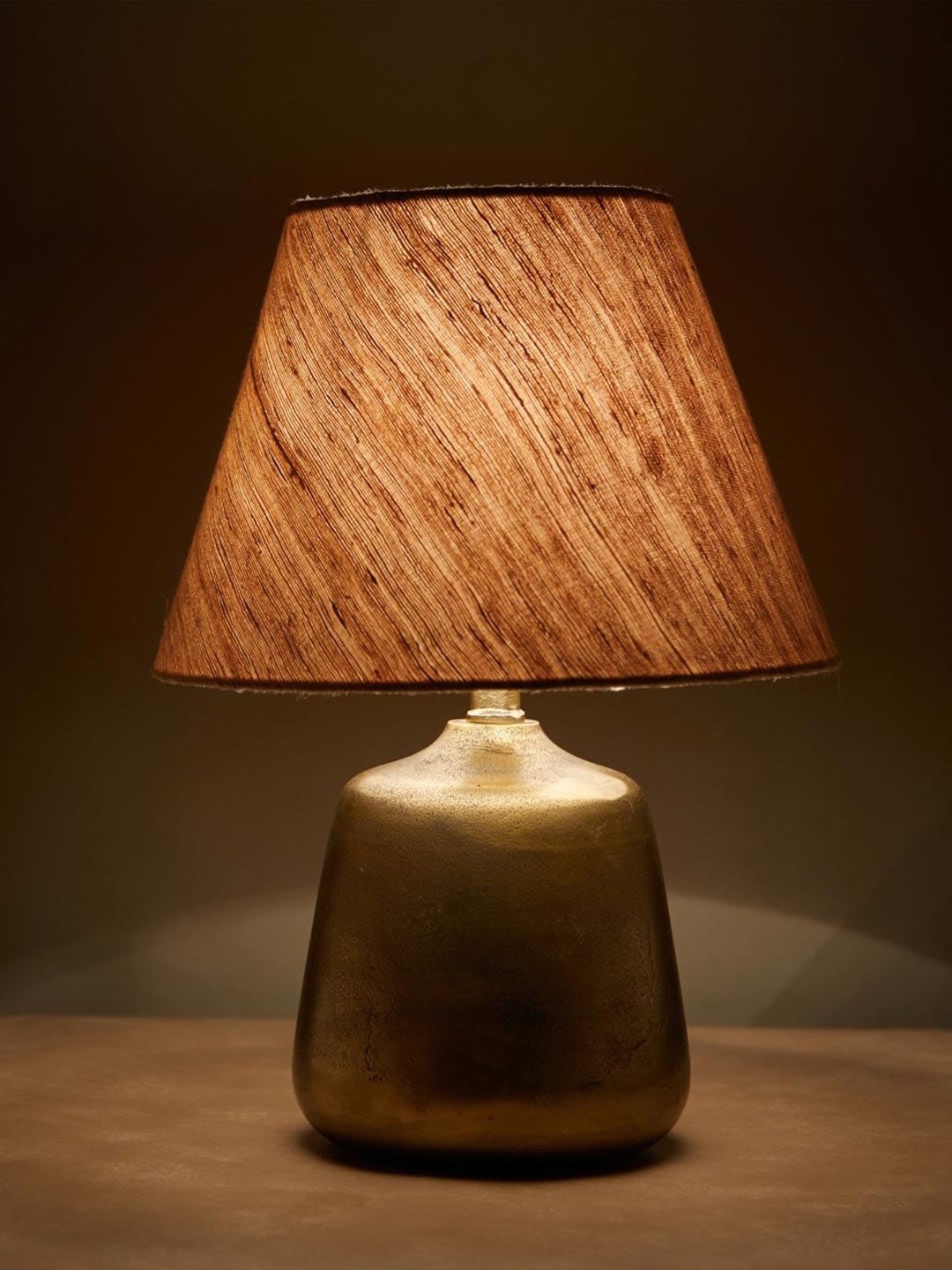 

Fabindia Varni Gold Toned & Peach-Coloured Textured Metal Small Table Lamp Without Shade