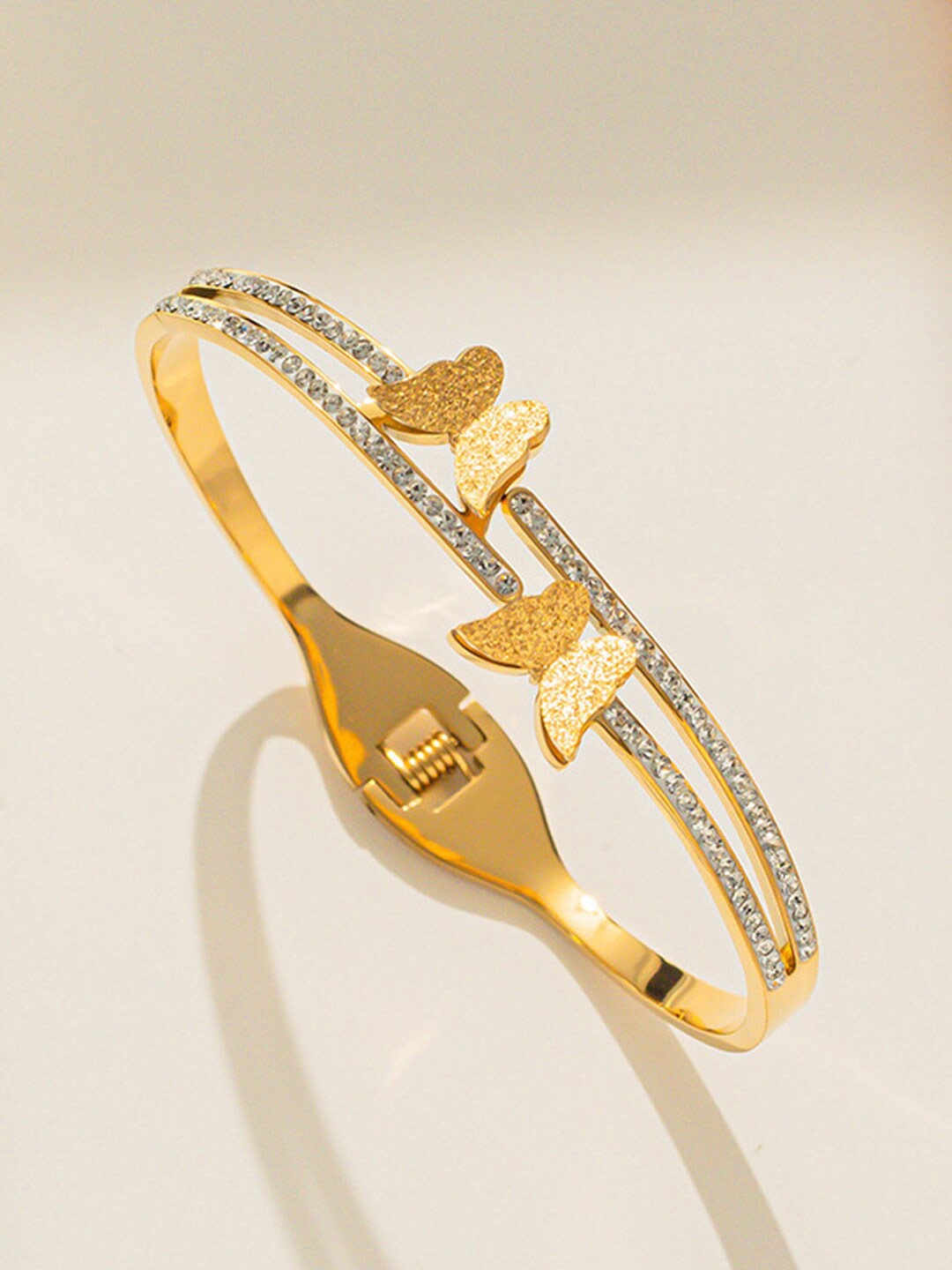 

Designs & You Stainless Steel American Diamond Gold-Plated Bangle-Style Bracelet