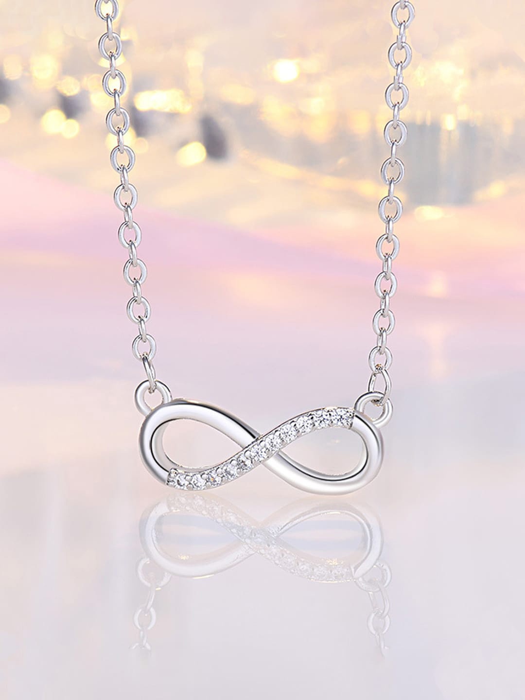 

Jewels Galaxy Silver-Plated AD-Studded Infinity Shaped Pendant With Chain
