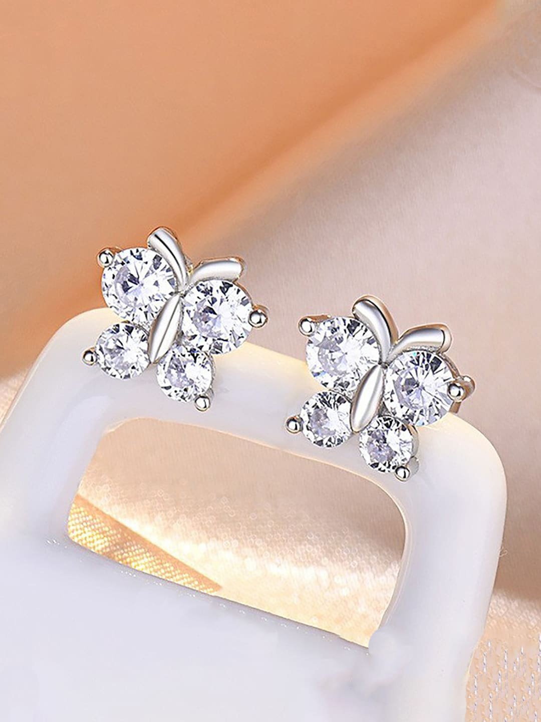 

Jewels Galaxy Silver Plated American Diamond-Studded Butterfly Shape Studs Earrings