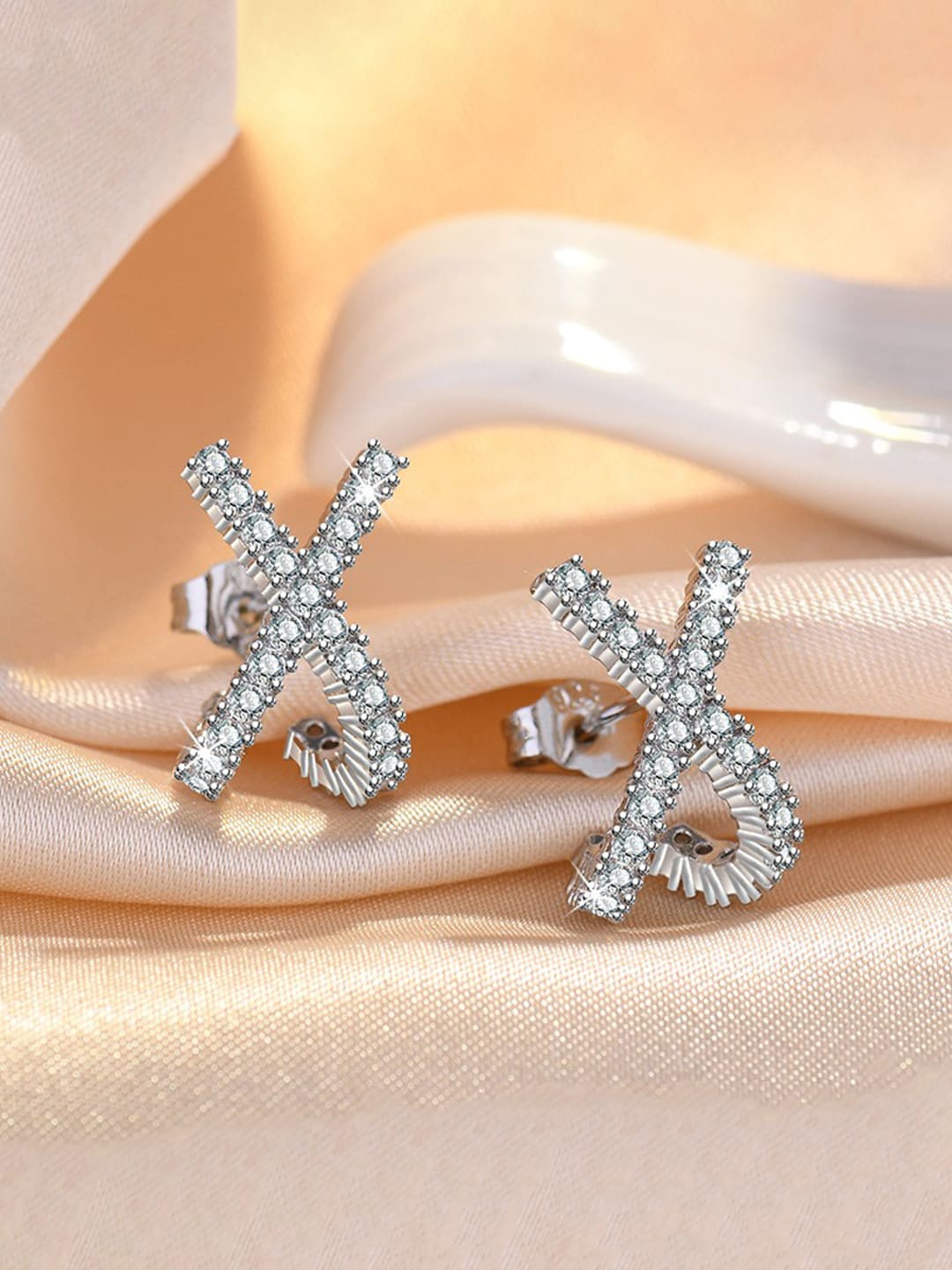 

Jewels Galaxy Silver-Plated American Diamond Studded Contemporary Studs Earrings