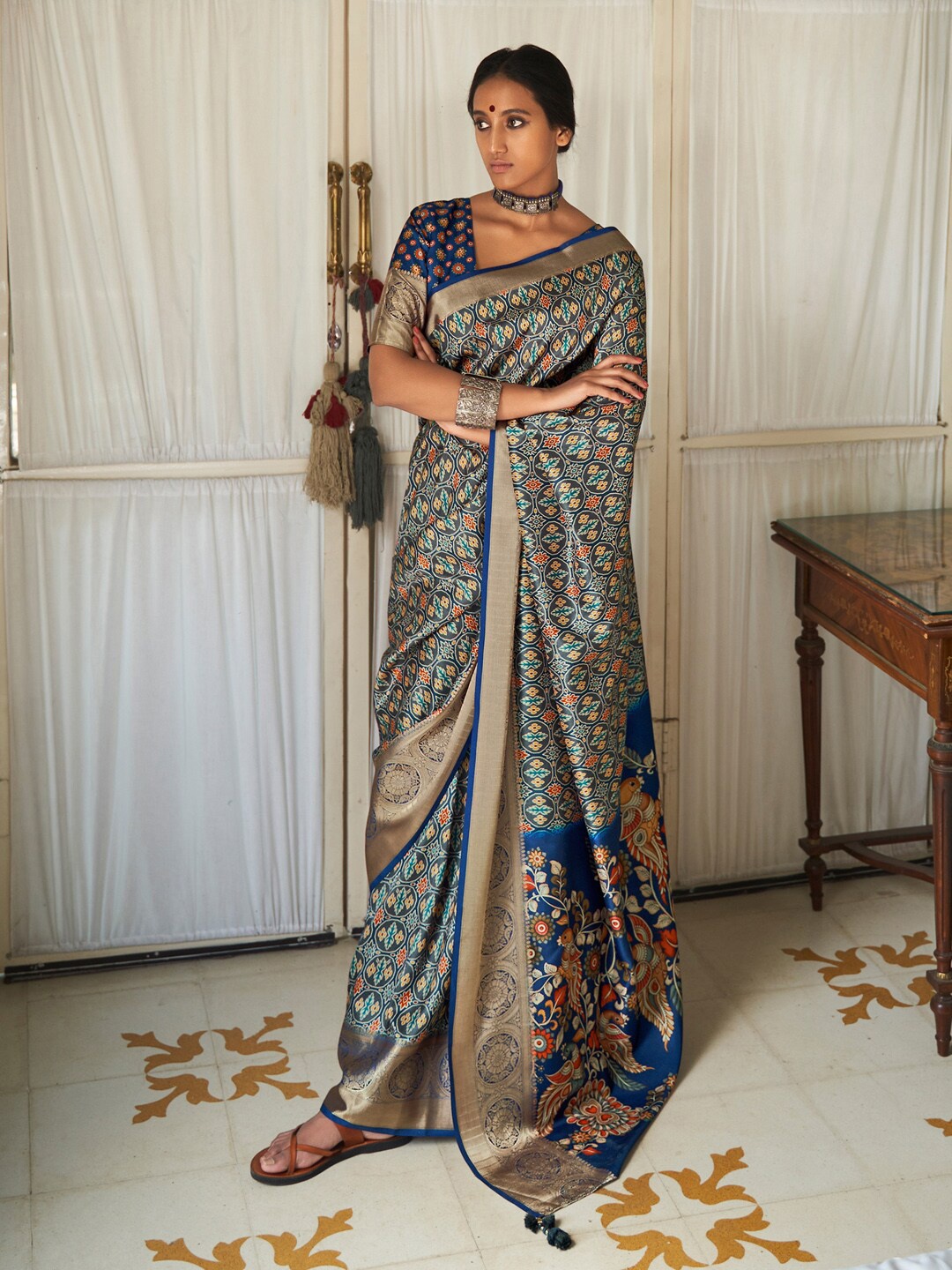 

Mitera Blue & Red Ethnic Motifs Printed Zari Ikat Saree