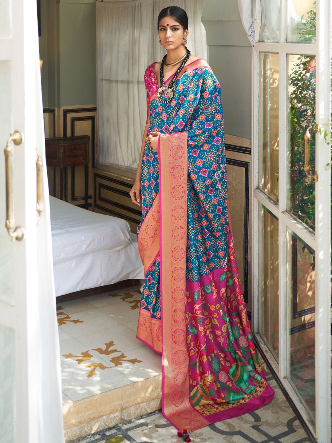 

Mitera Blue & Pink Ethnic Motifs Printed Zari Ikat Saree