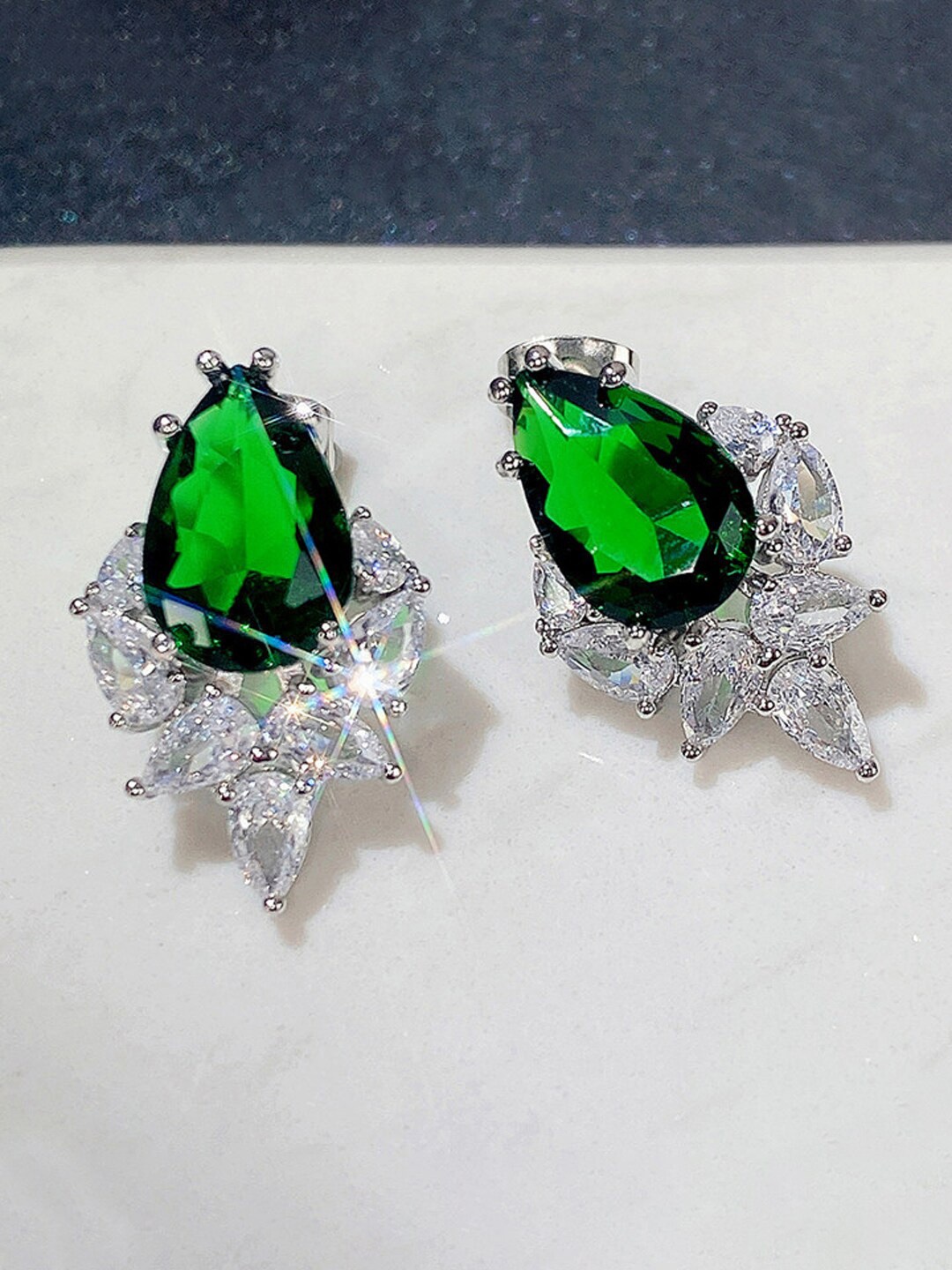 

Jewels Galaxy Silver-Plated Teardrop Shaped Studs Earrings