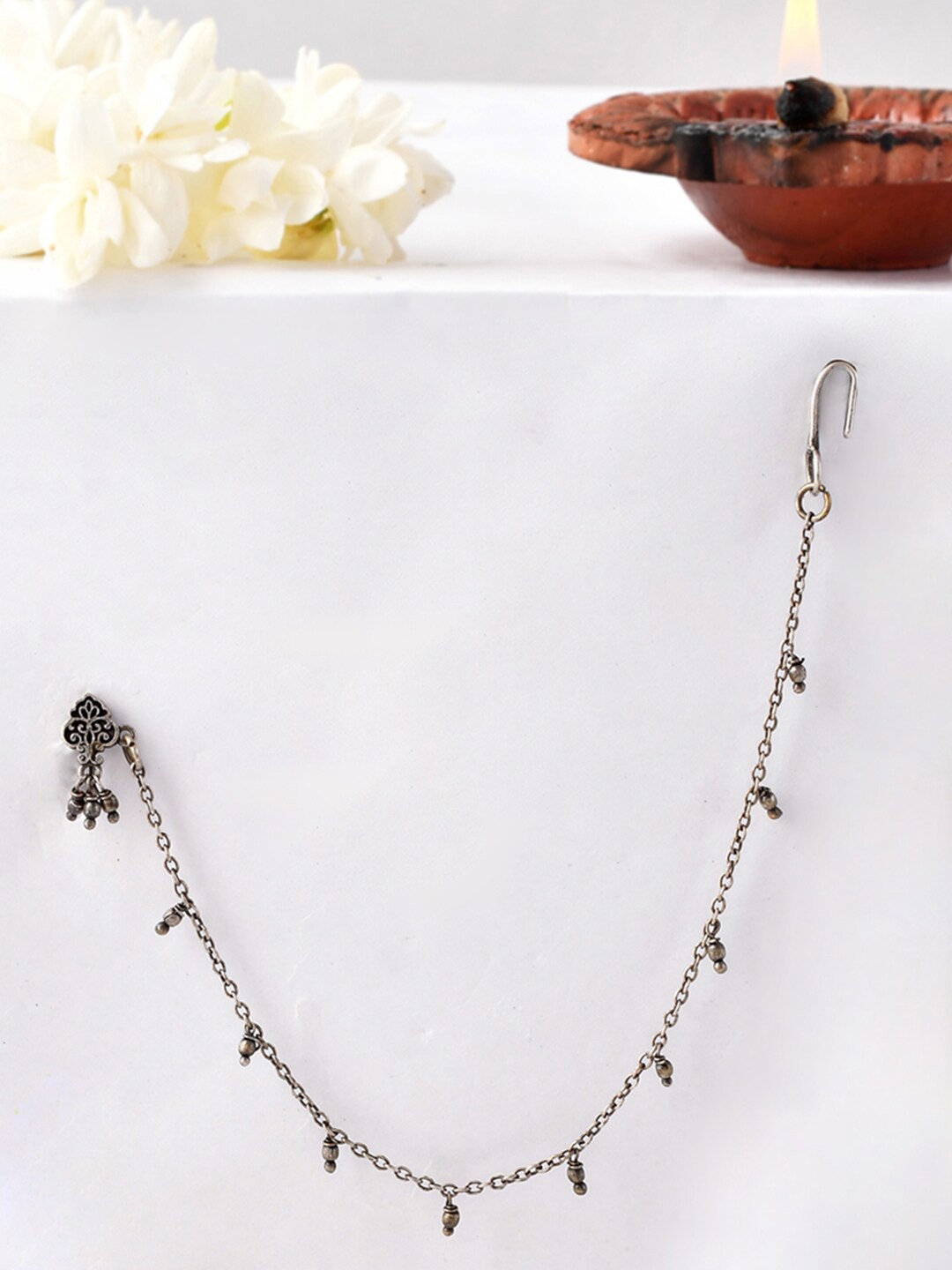 

Voylla Silver Plated Floral Shaped Chained Nose Pin