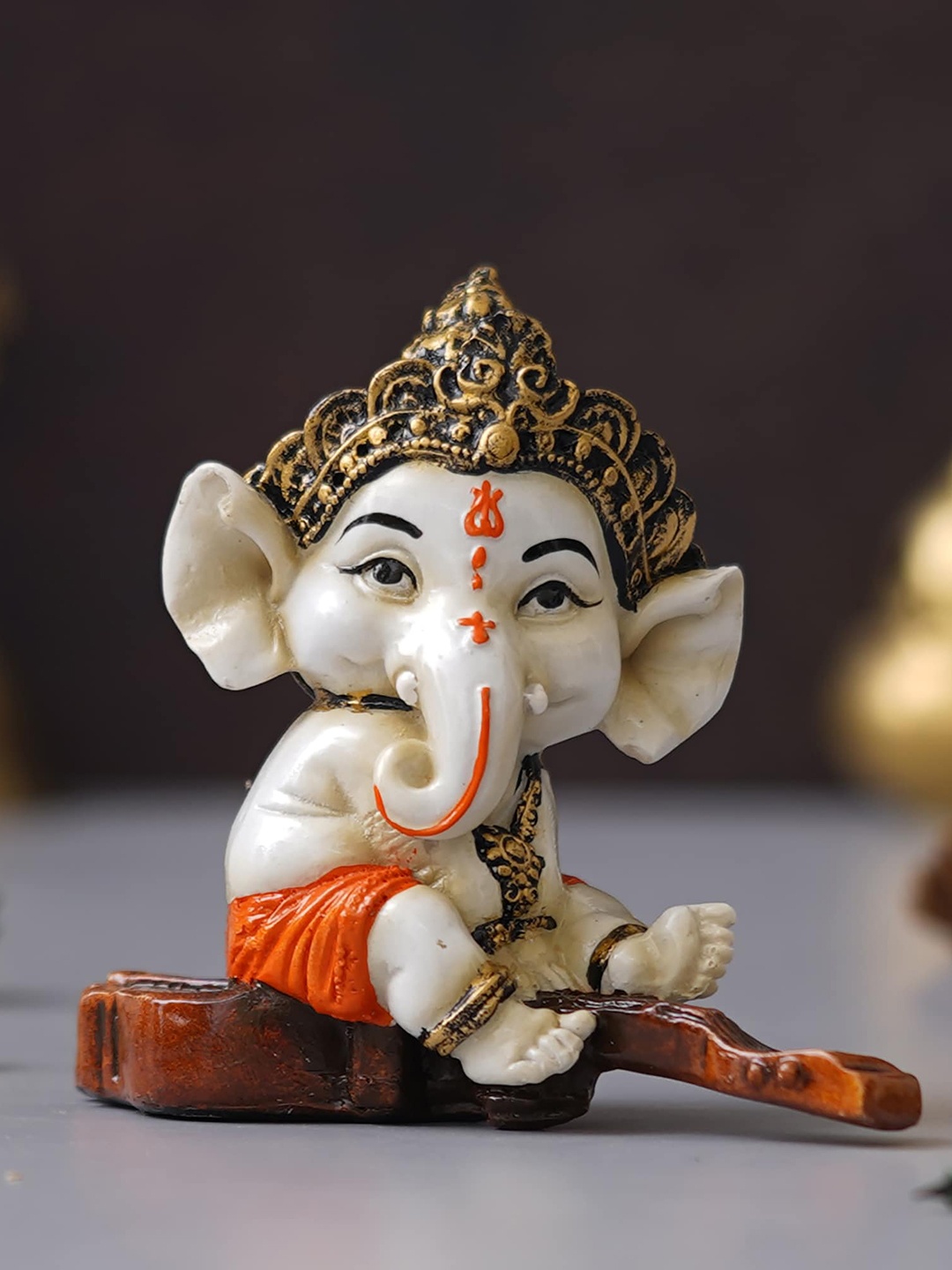 

eCraftIndia Orange Decorated Lord Ganesha Idol Sitting on Veena Showpiece