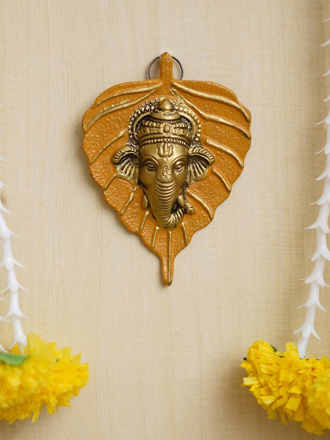 

eCraftIndia Yellow & Gold Toned Lord Ganesha Face On Peepal Leaf Wall Hanging