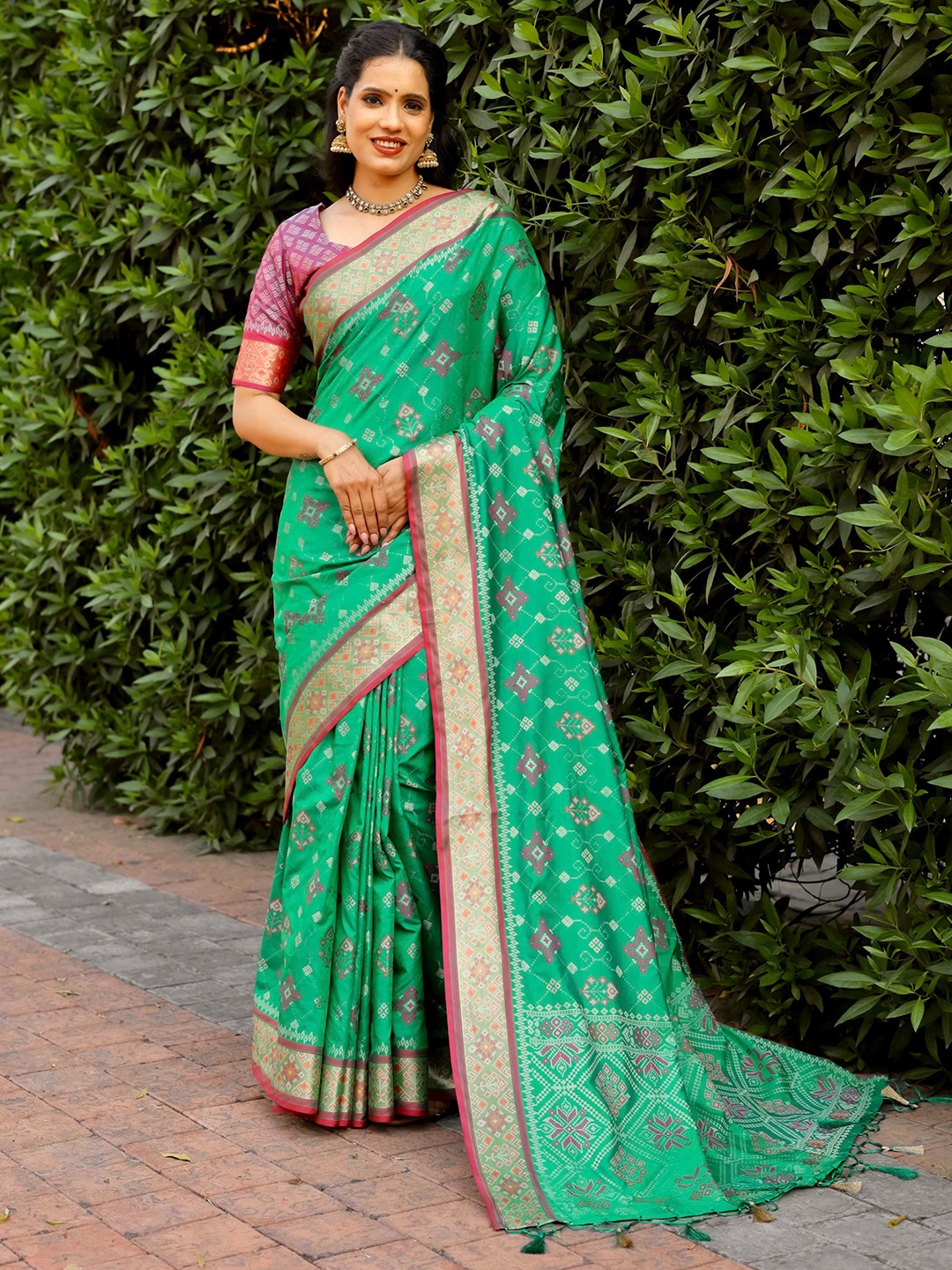 

Mitera Green & Red Floral Woven Design Zari Patola Saree