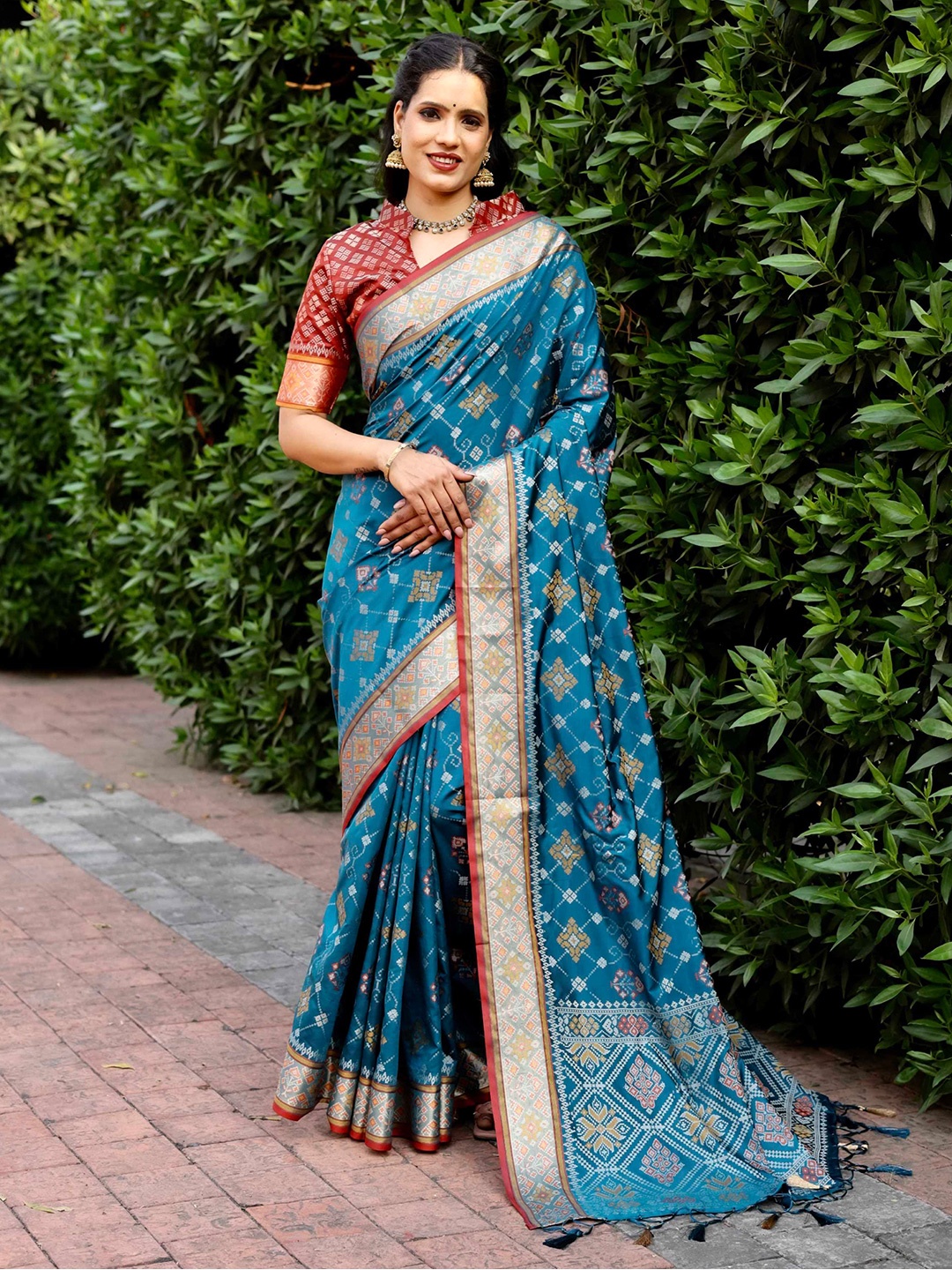 

Mitera Blue & Red Floral Woven Design Zari Patola Saree