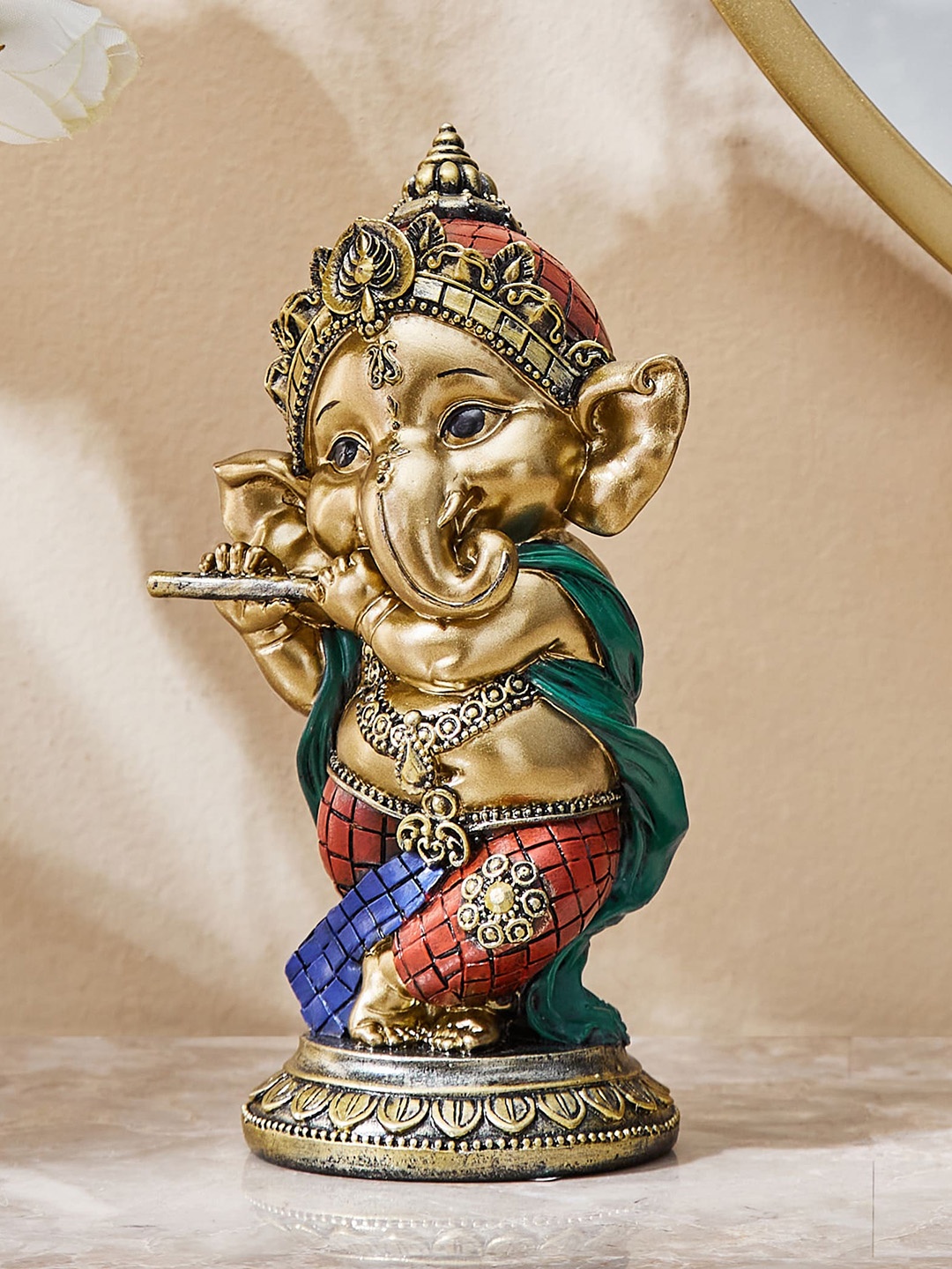 

Home Centre Alpana Red & Turquoise Blue Textured Baby Ganesha With Flute Showpiece, Gold