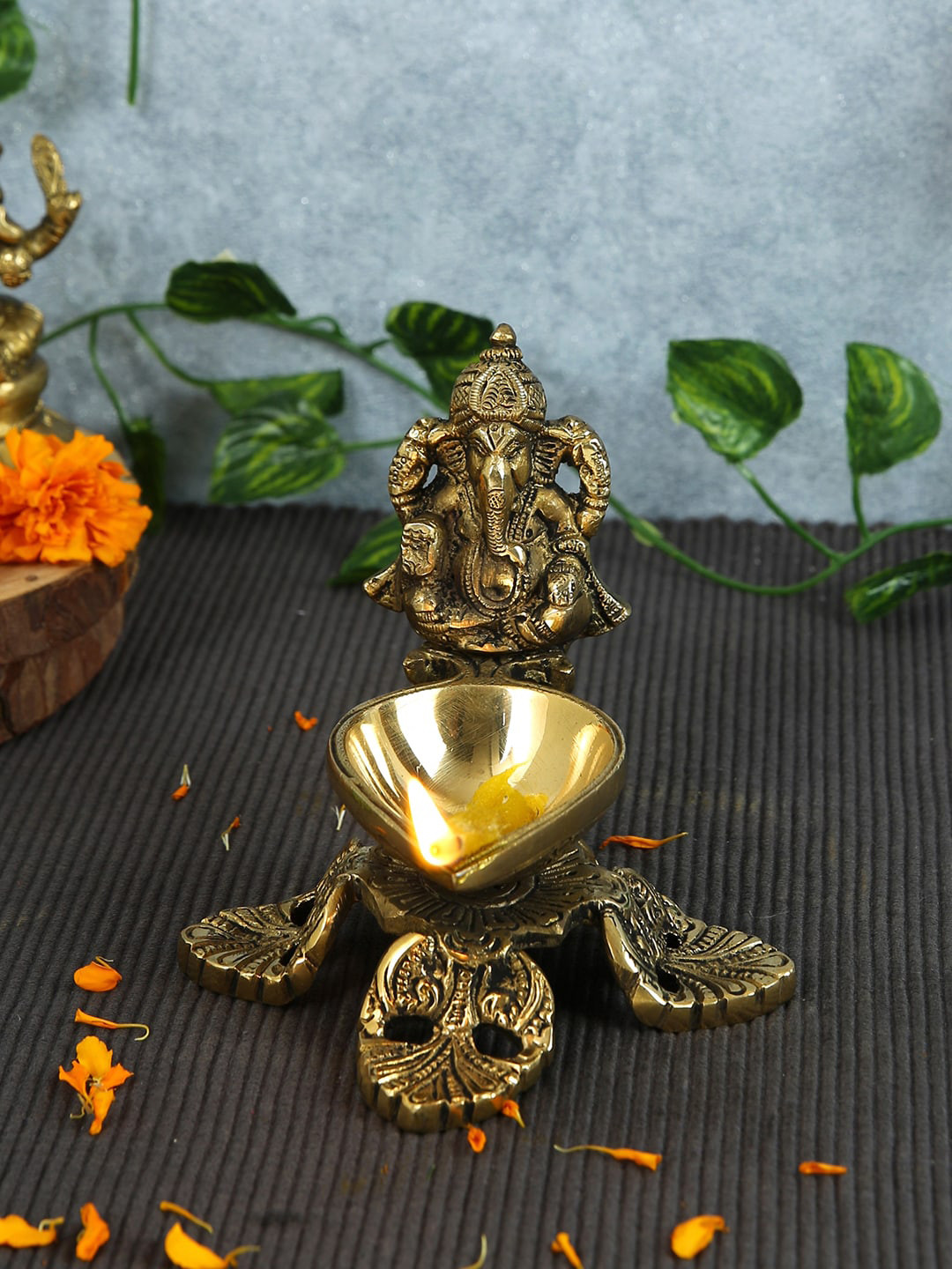 

Imli Street Gold Toned Ganesh Brass Diya With 4 Legs