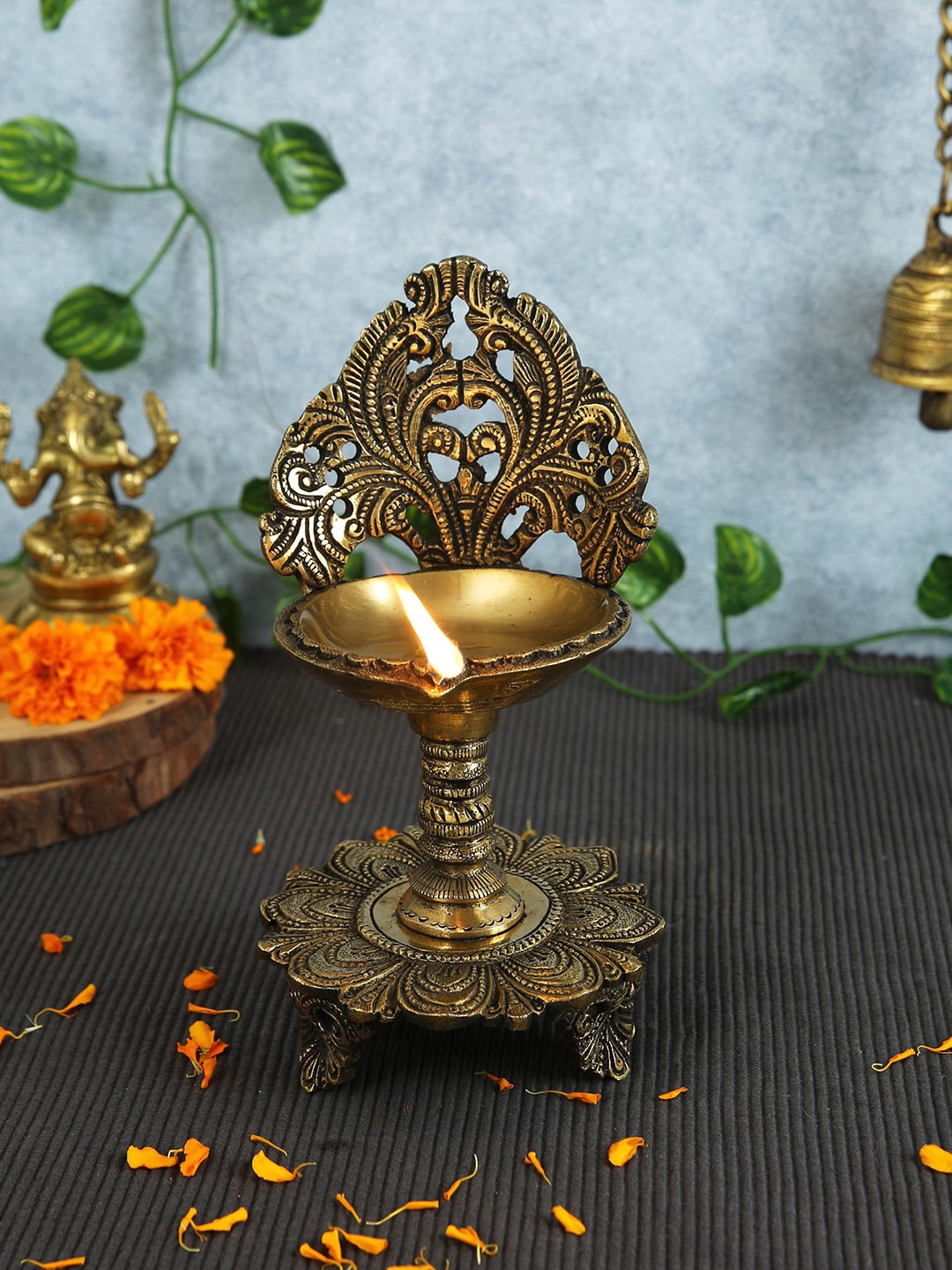 

Imli Street Gold Toned Tree Designed Brass Diya Lamp