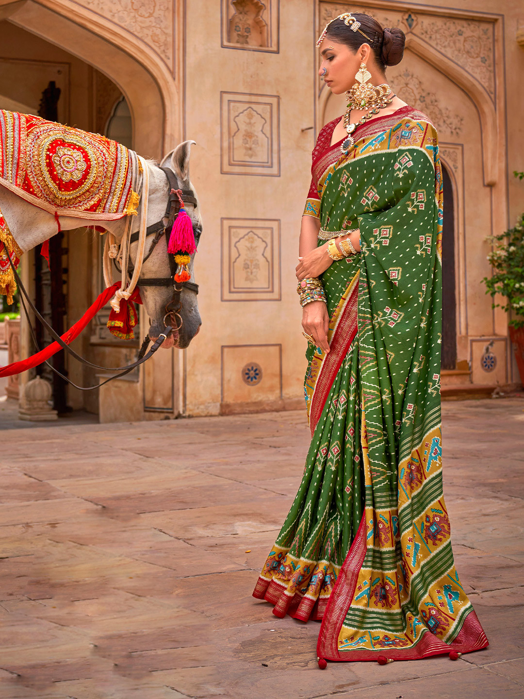 

Mitera Green & Red Ethnic Motifs Silk Blend Patola Saree