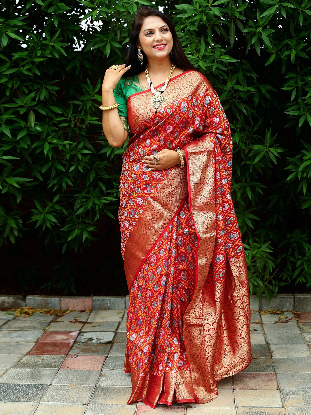 

Mitera Red & Green Ethnic Motifs Woven Design Zari Patola Saree