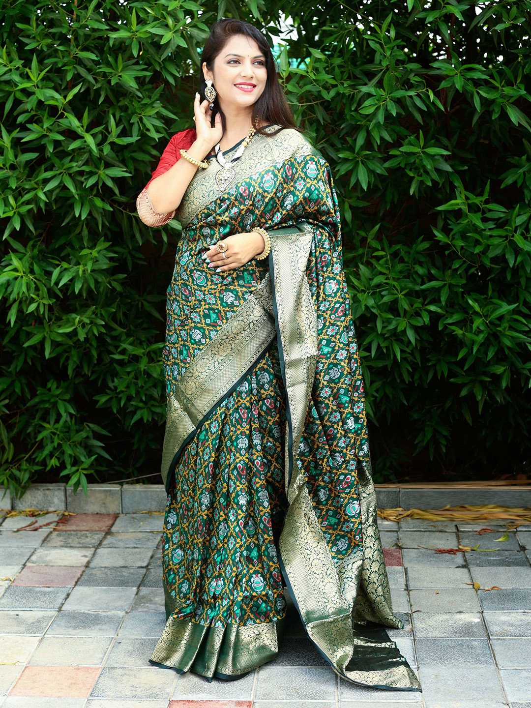 

Mitera Green & Red Woven Design Zari Patola Saree