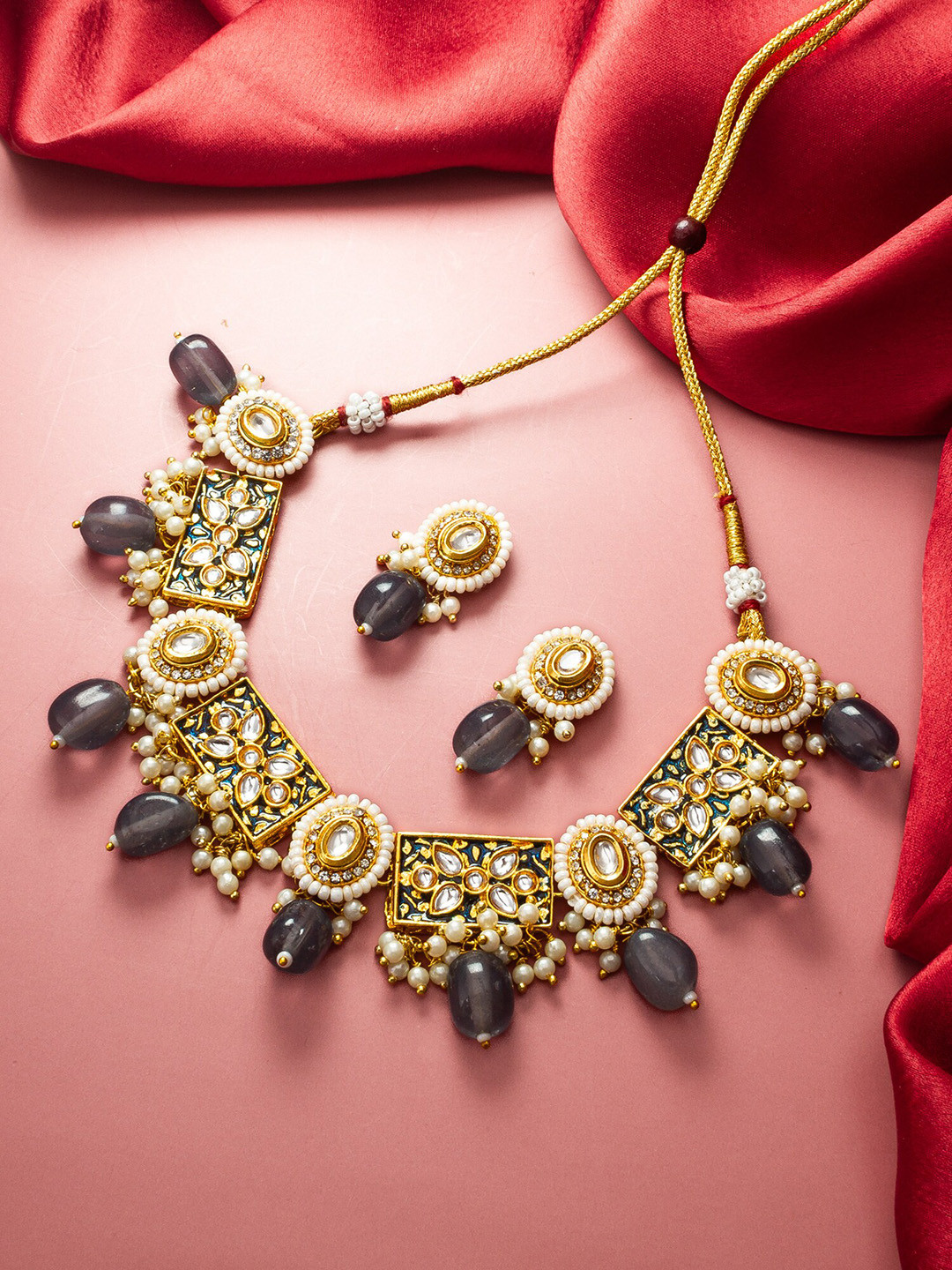

aadita Gold-Plated Stone-Studded & Beaded Jewellery Set