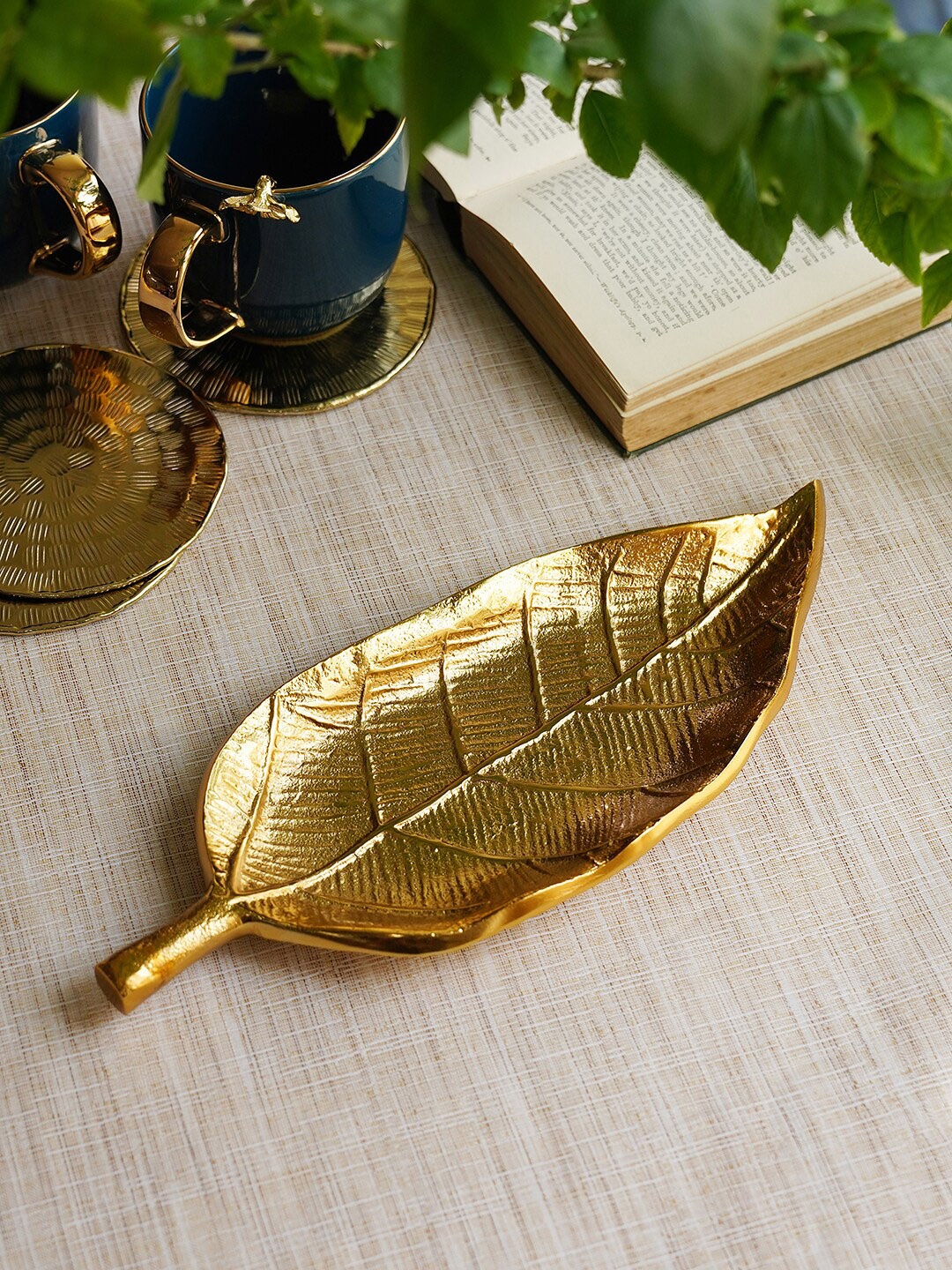 

Pure Home and Living Gold Toned Textured Long Leaf Metal Figurine Showpiece