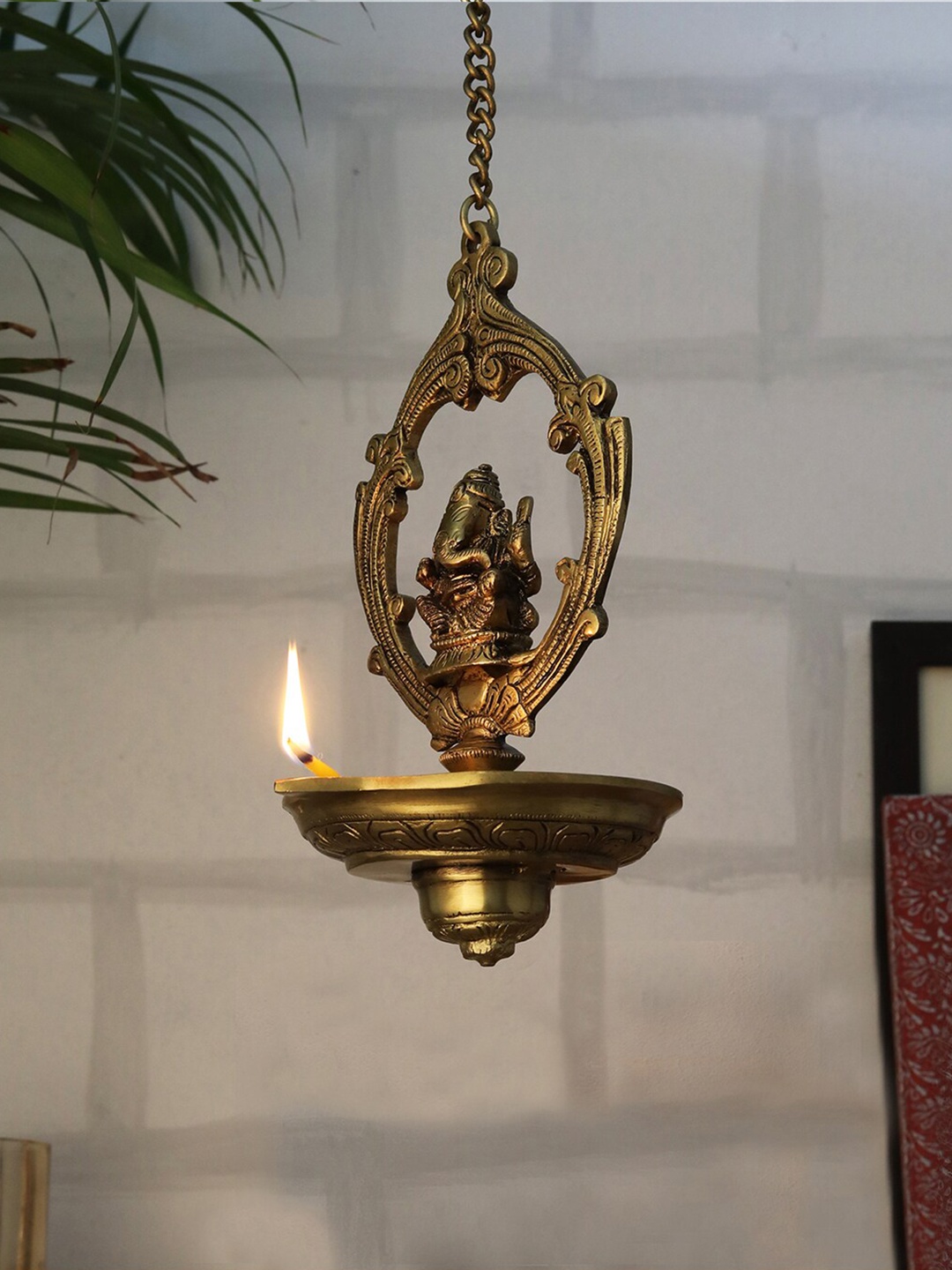 

Two Moustaches Gold Toned Ganesha Design Wall Hanging Diya