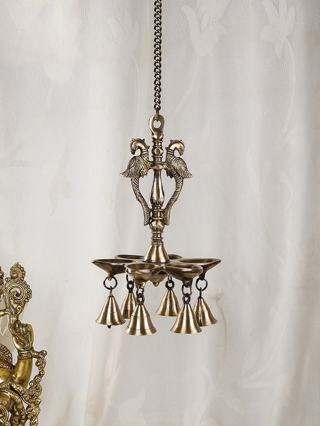 

Two Moustaches Gold Toned Peacock Design Wall Hanging Diya