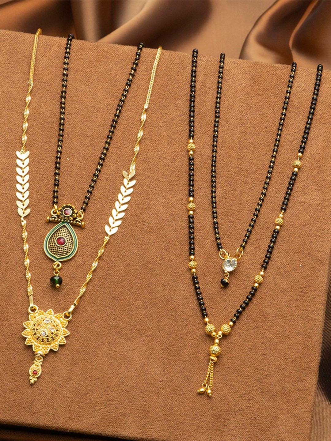 

Ramdev Art Fashion Jwellery Set Of 4 Gold-Plated Stones-Stones & Beaded Mangalsutra