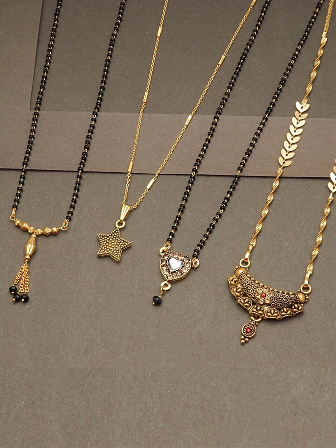 

Ramdev Art Fashion Jwellery Set Of 4 Gold-Plated Stone-Studded & Beaded Mangalsutra