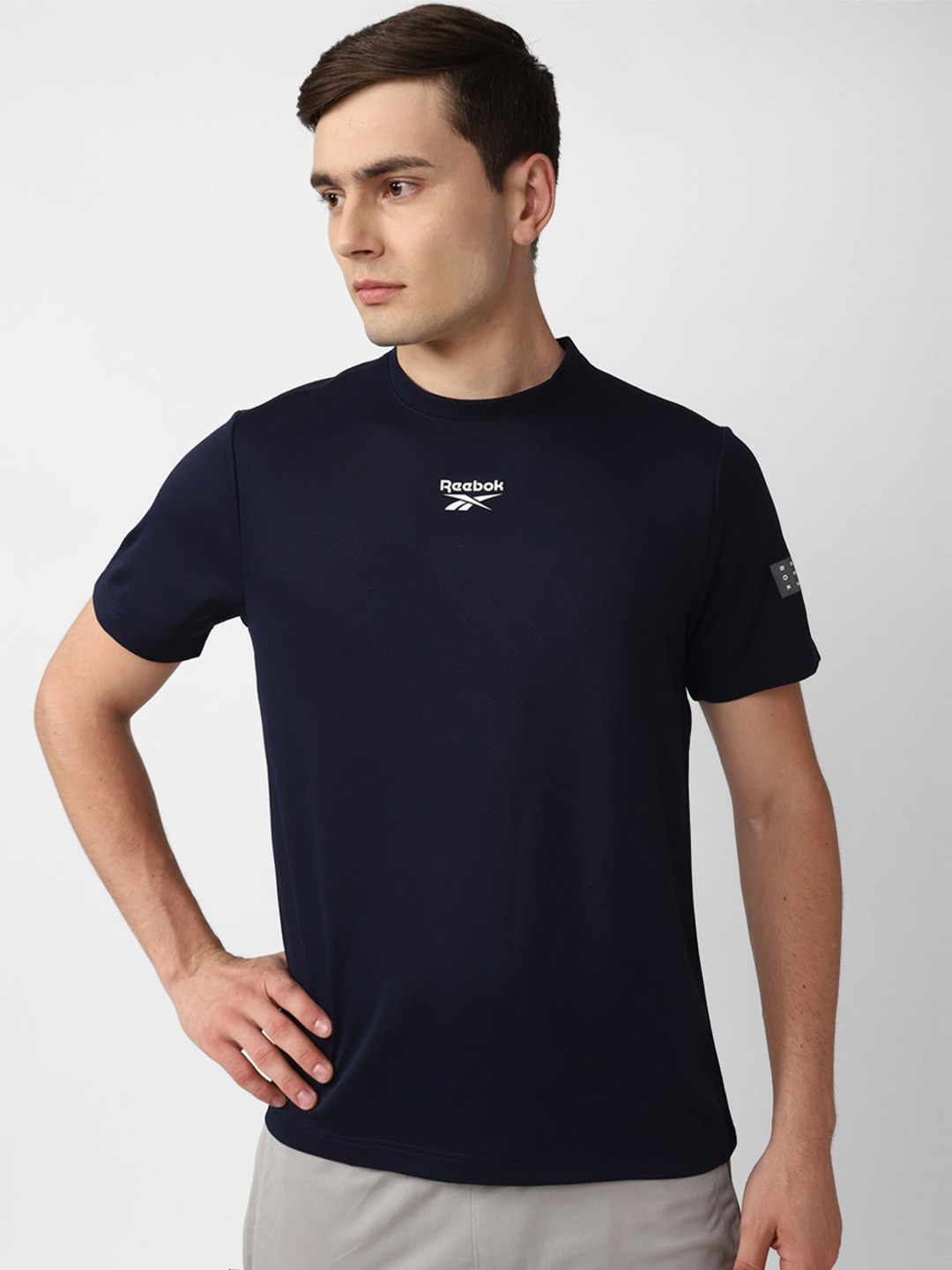 

Reebok Tag Brand Logo Graphic Printed Crew Neck T-Shirt, Navy blue
