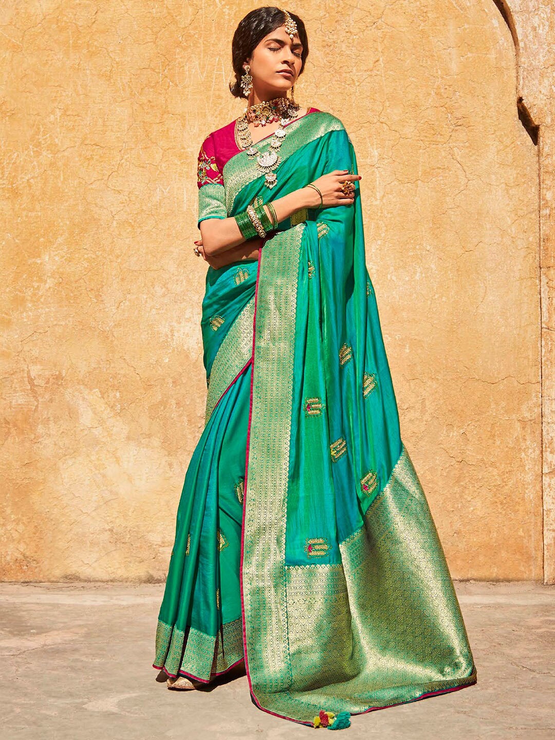 

Mitera Teal & Magenta Ethnic Motifs Embroidered Zari Saree