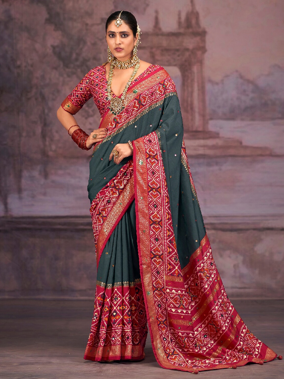 

Mitera Grey & Red Embellished Mirror Work Silk Cotton Patola Saree