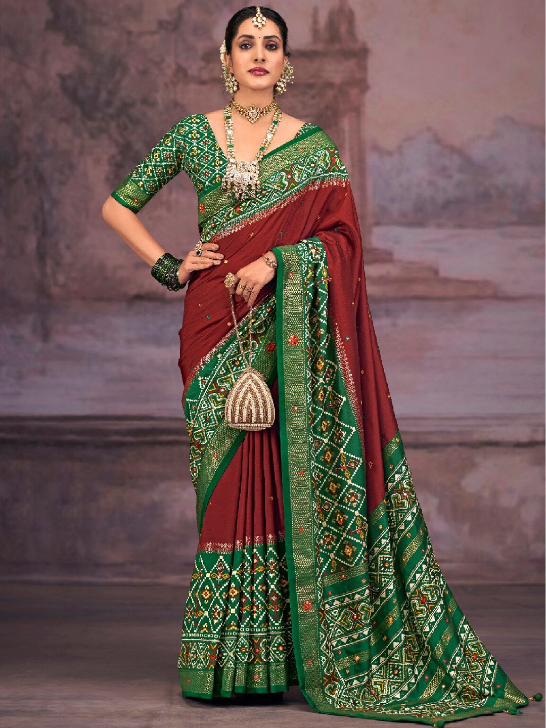 

Mitera Burgundy & Green Ethnic Motifs Printed Mirror Work Silk Cotton Patola Saree